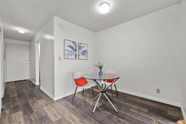 a view of a room with wooden floor and bench