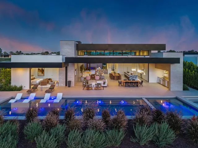 a front view of a house with a yard and a garage