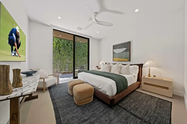 a bedroom with a bed and a large window