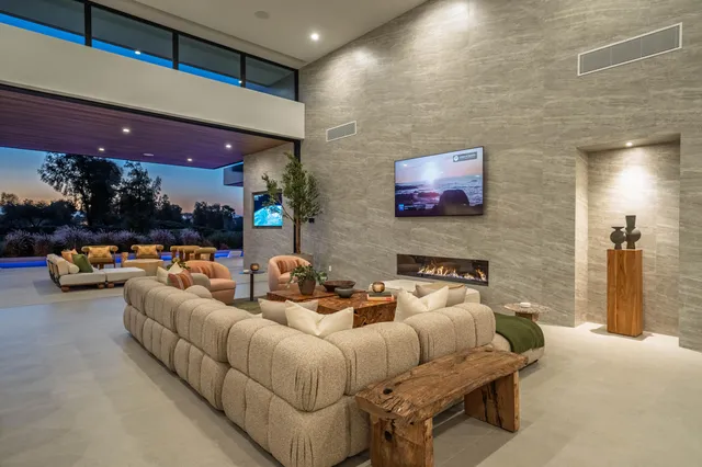 a spacious bedroom with a bed and glass windows