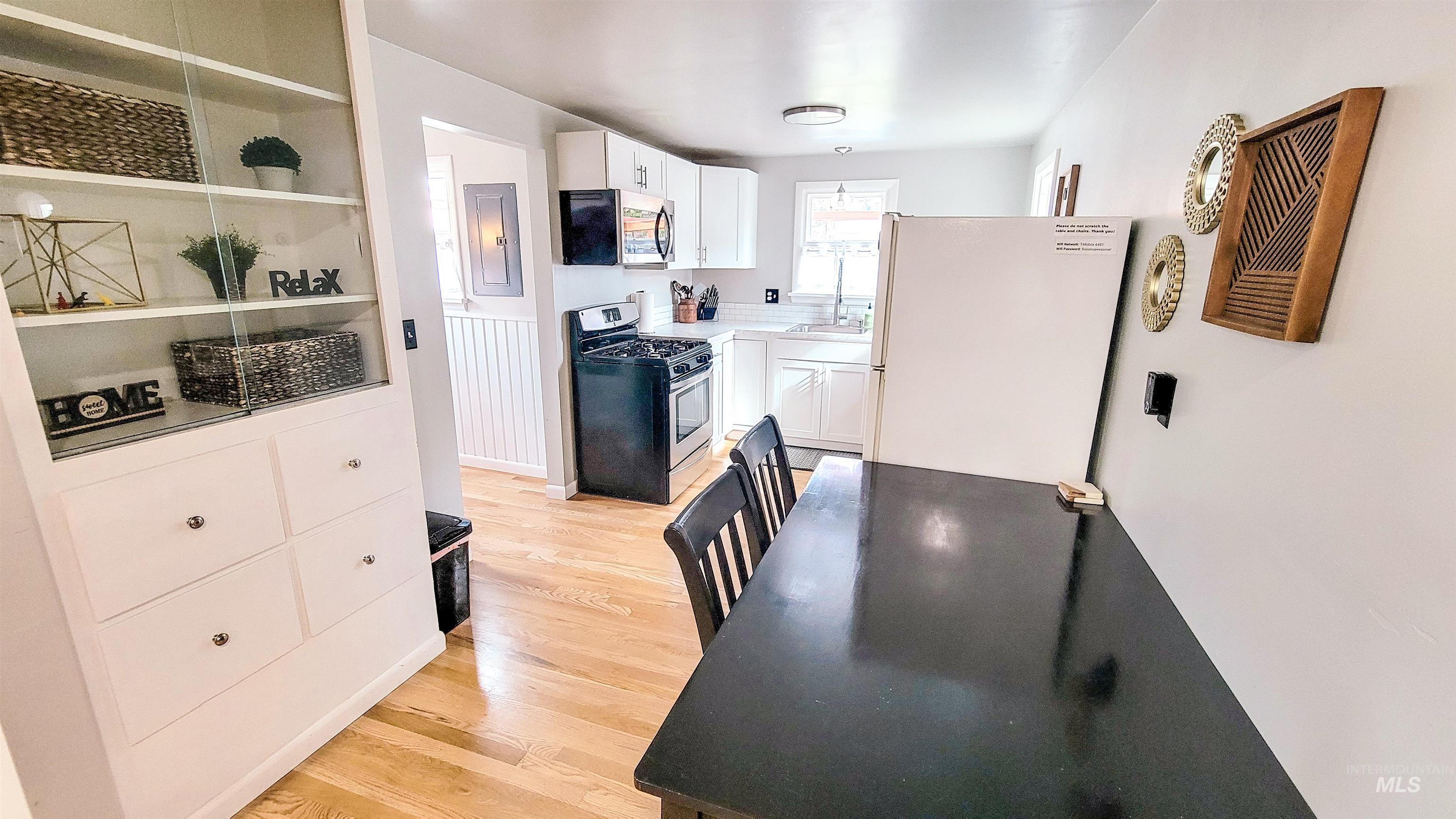 814 Baker Street Boise, ID 83706 - Photo 6 of 26 Kitchen and dining area featuring light wood-finish flooring