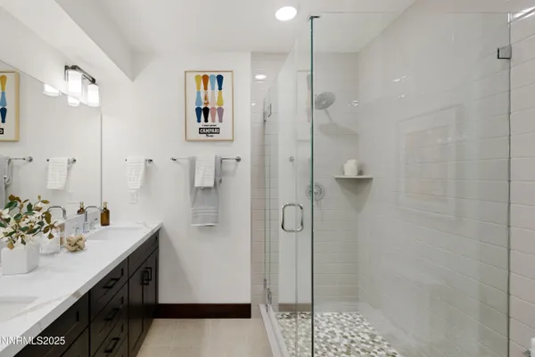 a spacious bathroom with a shower sink and mirror