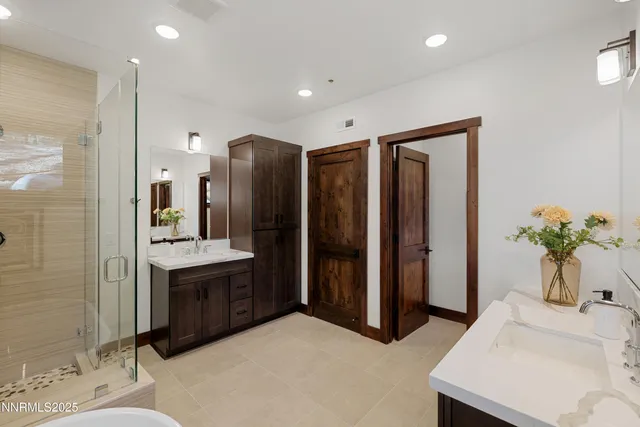 a spacious bathroom with a double vanity sink and a mirror