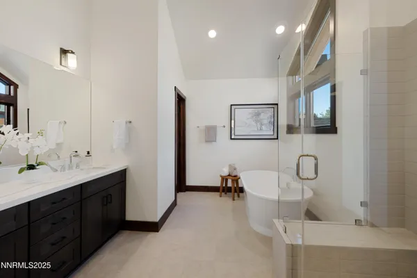 a spacious bathroom with a double vanity sink double mirror and bathtub