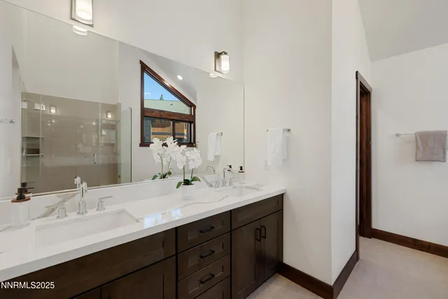 a bathroom with a double vanity sink mirror and double