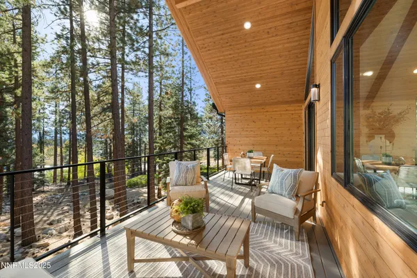 a view of a balcony with couch and wooden floor