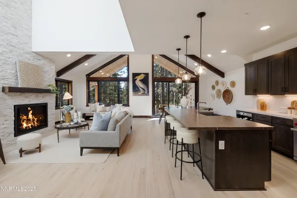 a living room with furniture a fireplace and a table