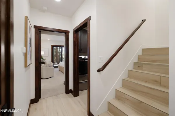 a view of staircase with wooden floor and a bathroom