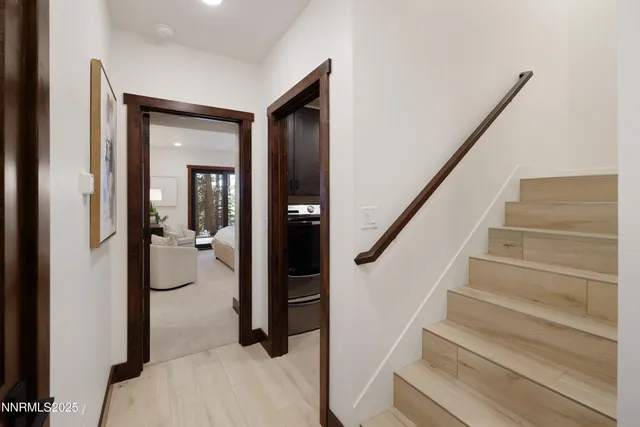 a view of staircase with wooden floor and a bathroom