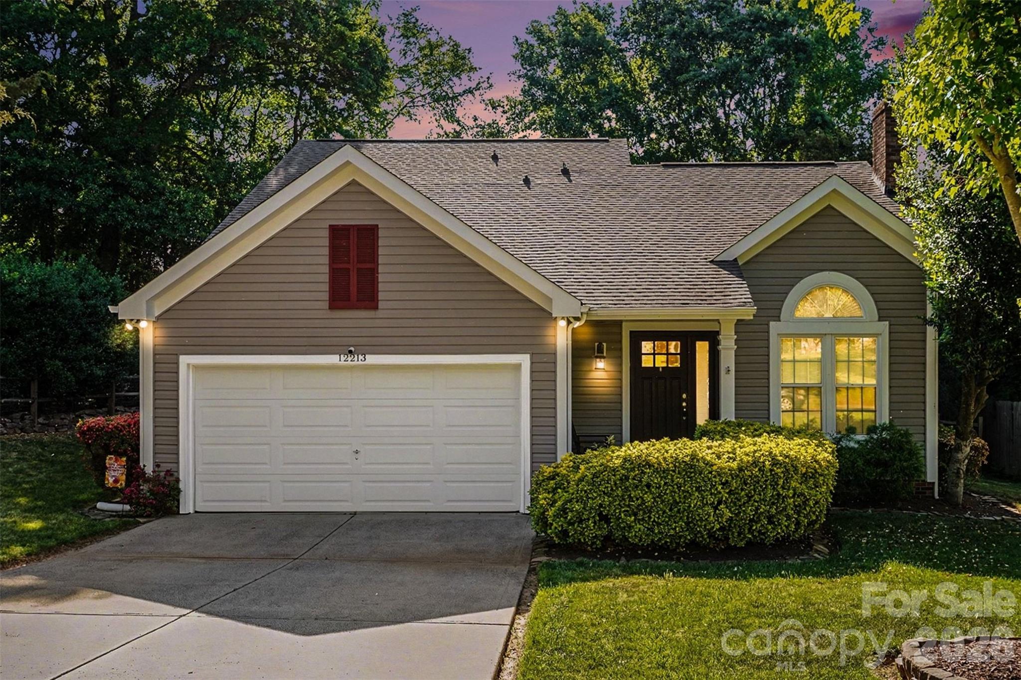 12213 Woodside Falls Road Pineville, NC 28134 - Photo 1 of 28 a view of a house with a yard plants and large tree