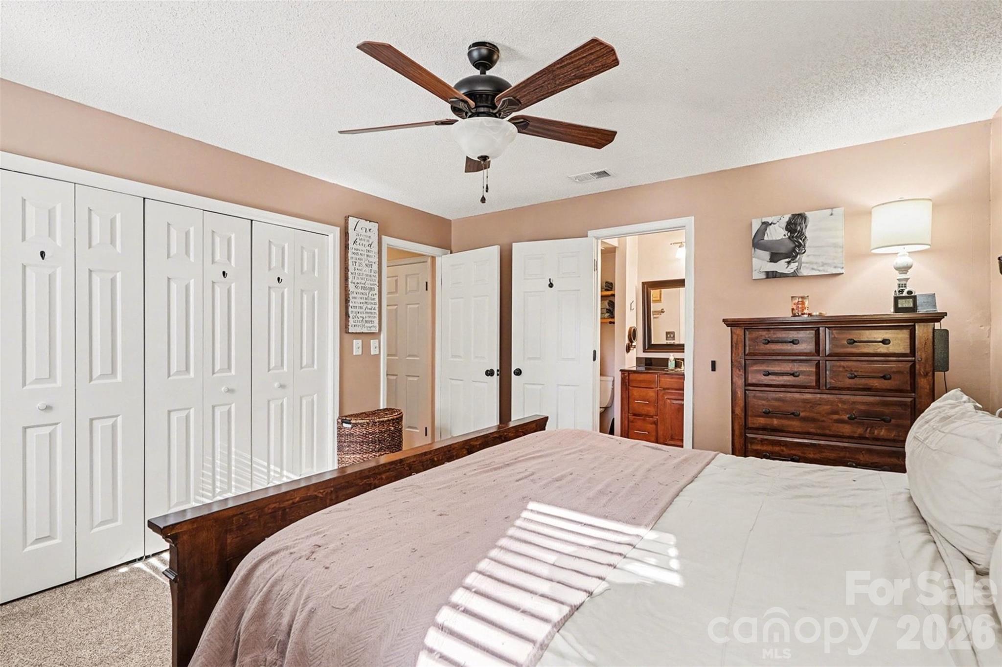 12213 Woodside Falls Road Pineville, NC 28134 - Photo 15 of 28 a bedroom with a bed dresser and a closet