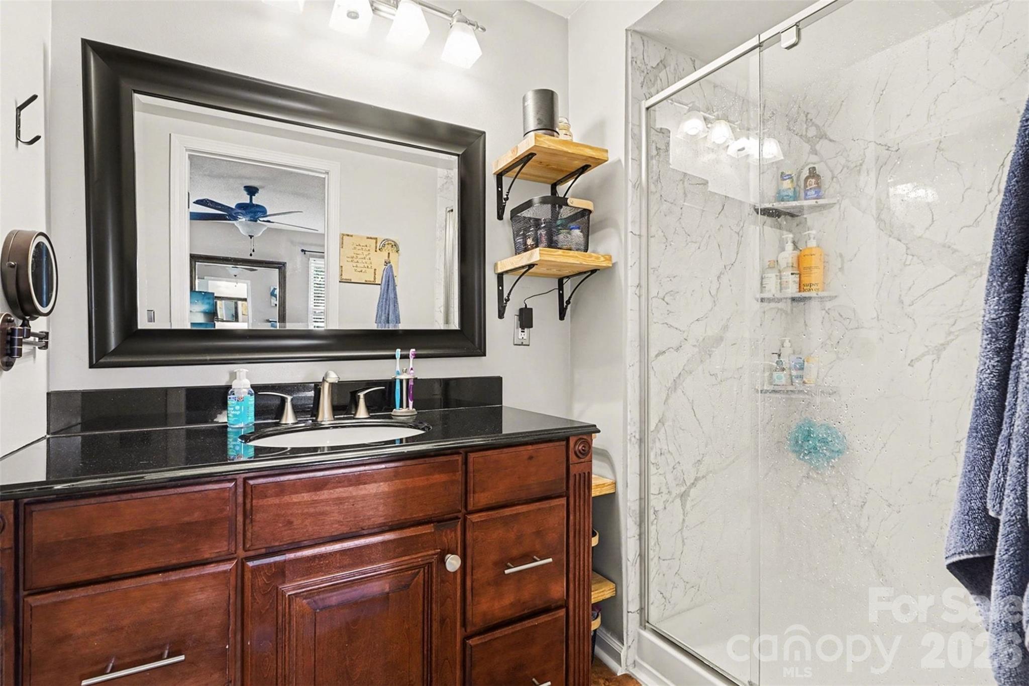 12213 Woodside Falls Road Pineville, NC 28134 - Photo 19 of 28 a bathroom with a sink and a mirror