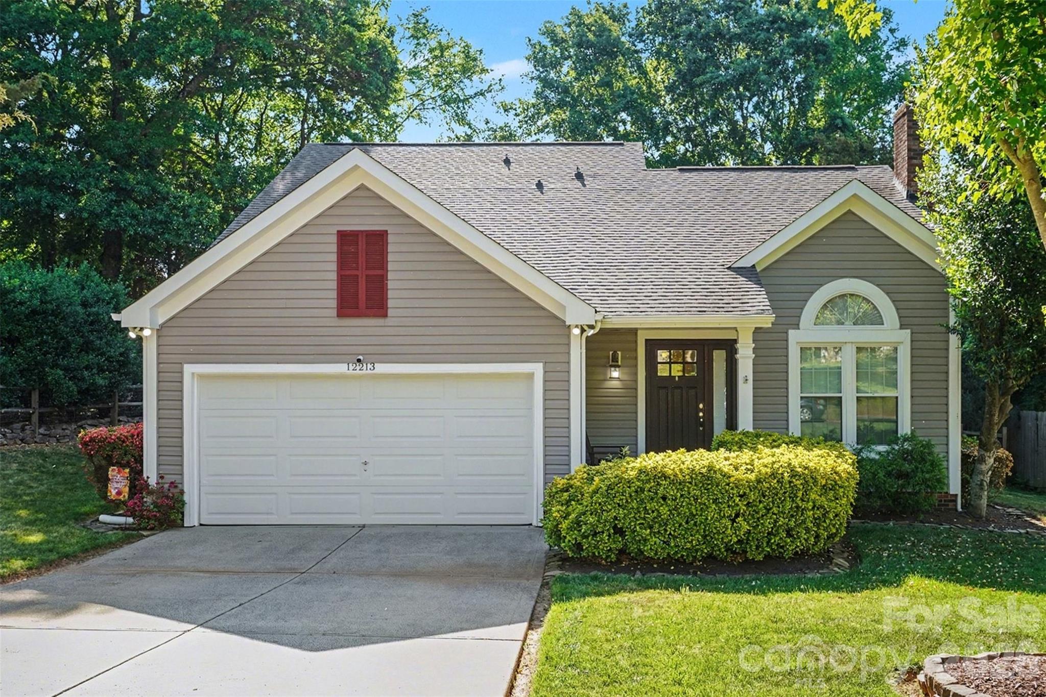 12213 Woodside Falls Road Pineville, NC 28134 - Photo 2 of 28 a view of a house with a yard plants and large tree