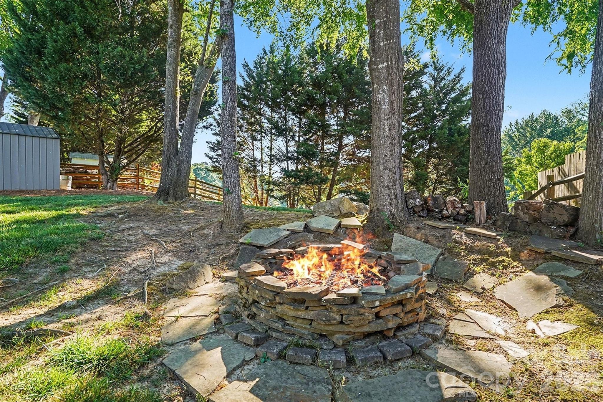 12213 Woodside Falls Road Pineville, NC 28134 - Photo 26 of 28 a view of a backyard with table and chairs