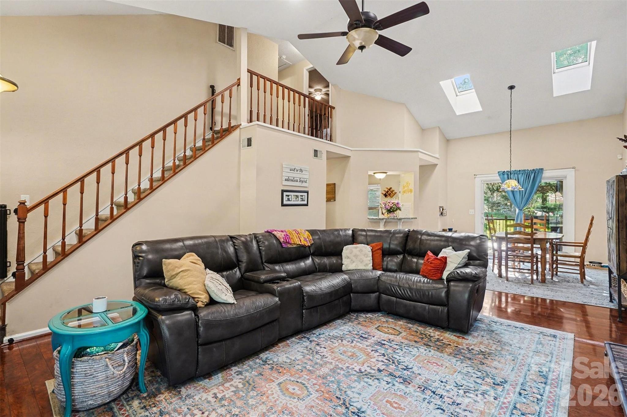12213 Woodside Falls Road Pineville, NC 28134 - Photo 5 of 28 a living room with furniture ceiling fan and a rug