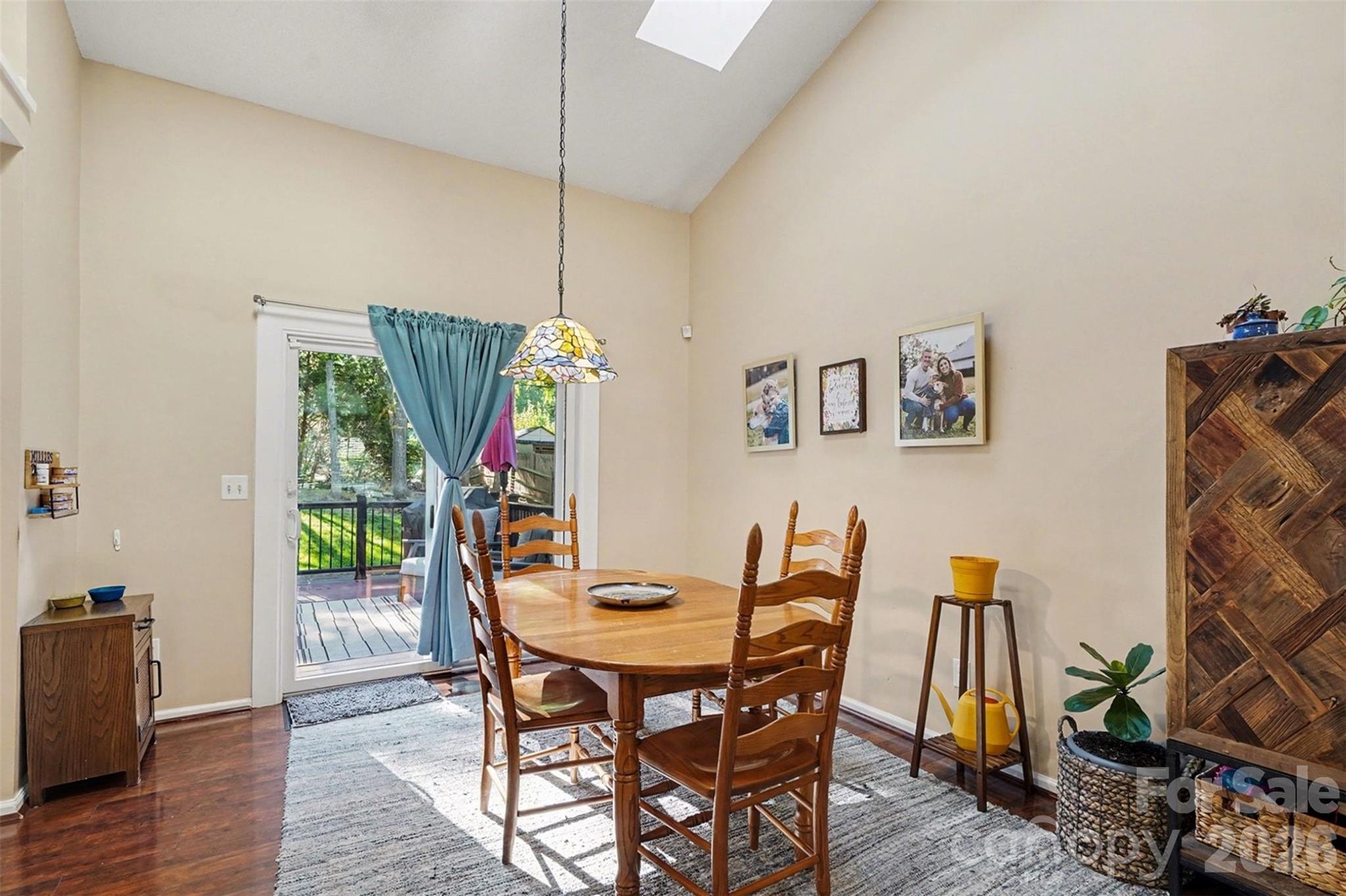 12213 Woodside Falls Road Pineville, NC 28134 - Photo 8 of 28 a view of a dining room with furniture and wooden floor