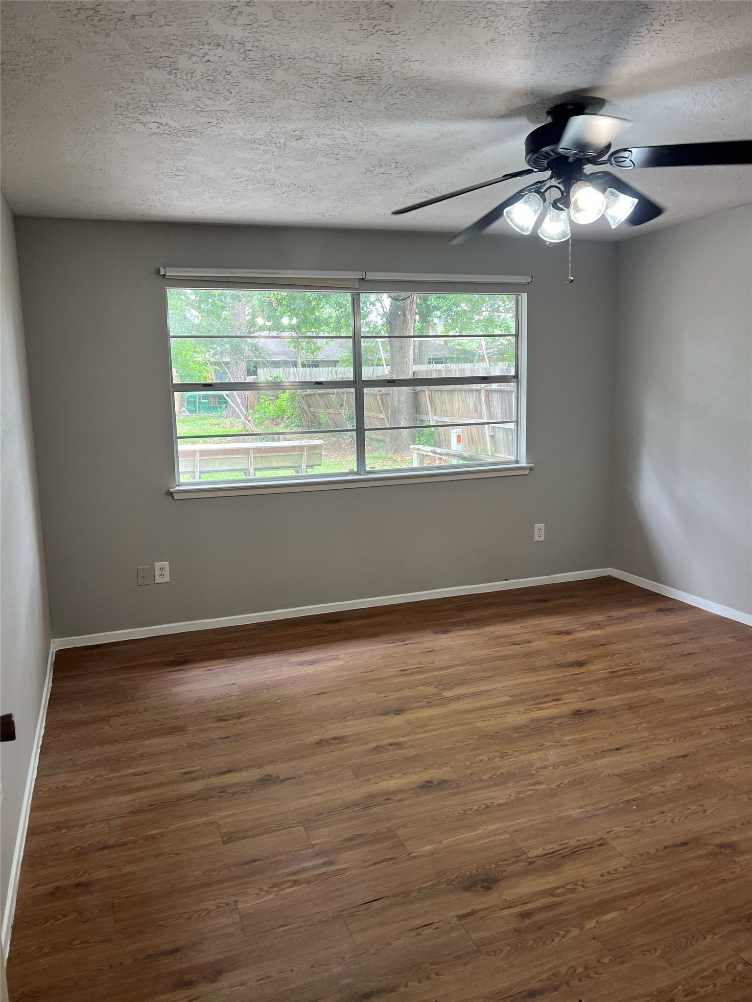 6507 Bridgegate Drive Spring, TX 77373 - Photo 8 of 17 a view of an empty room with wooden floor and a window