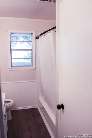 a bathroom with a shower and a toilet