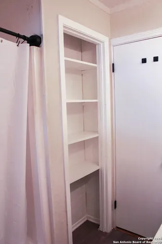 a view of walk in closet with empty racks
