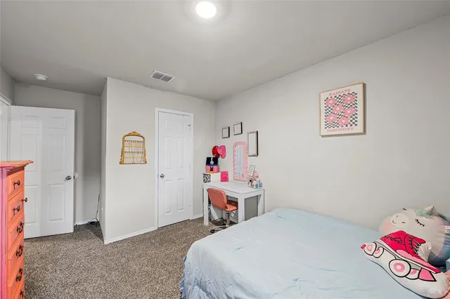 a bedroom with a bed and a desk