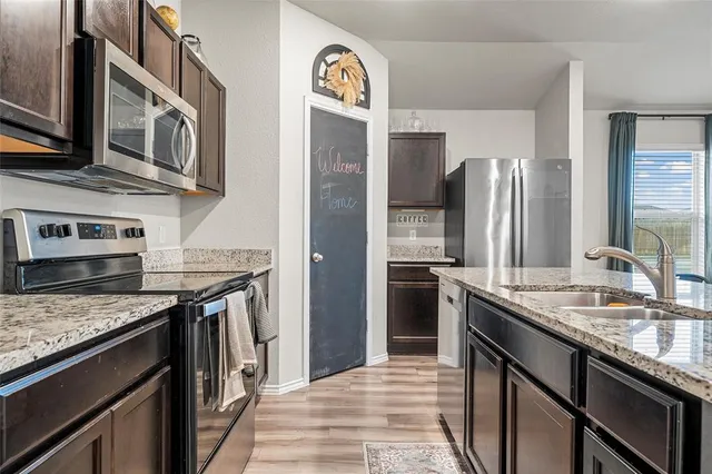 a kitchen with stainless steel appliances granite countertop a stove and a refrigerator