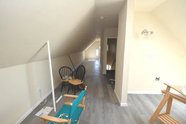a view of living room with furniture and wooden floor