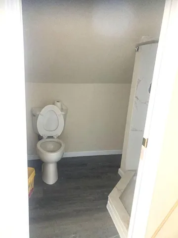 a white toilet sitting next to a white sink