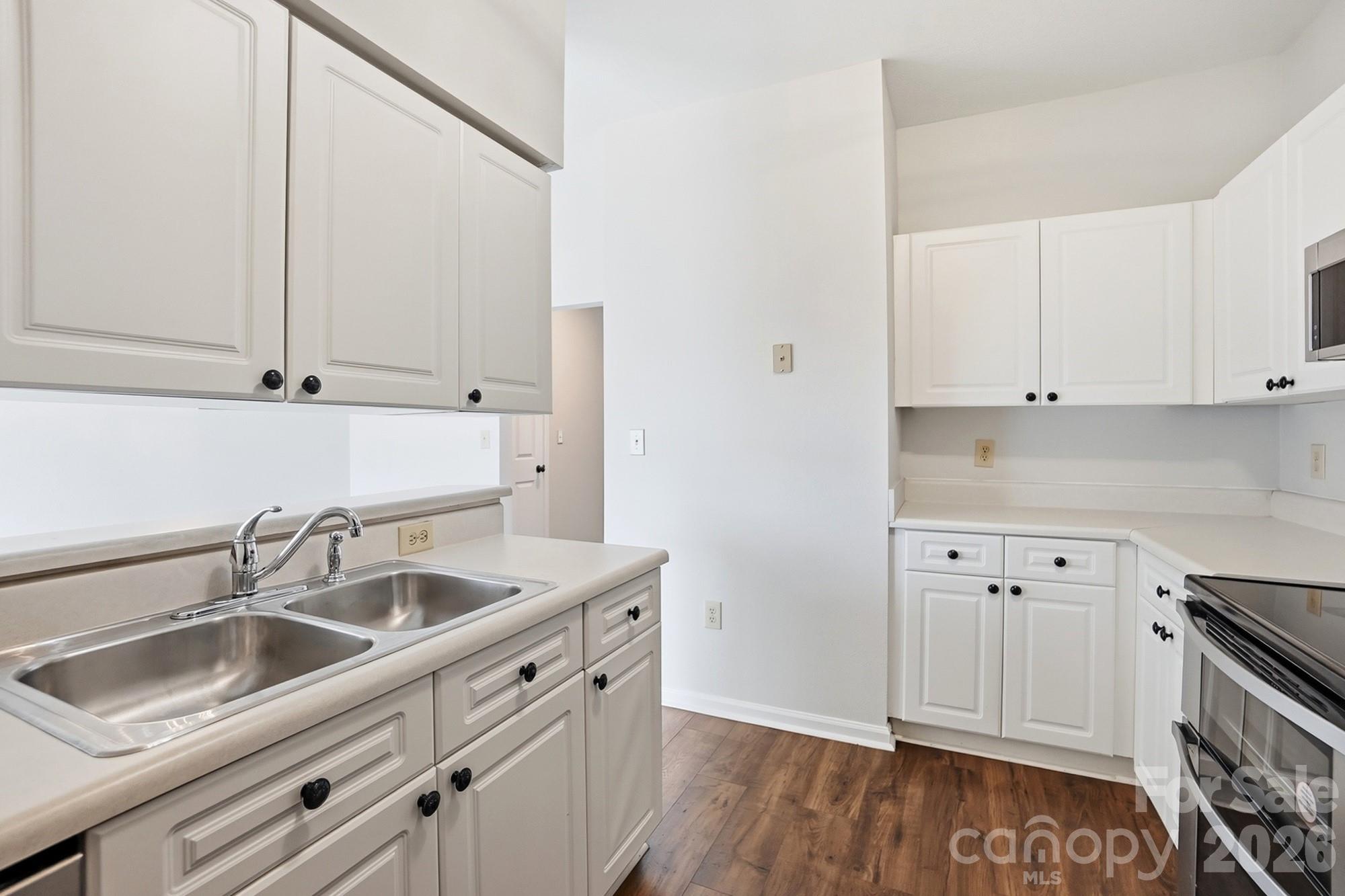 711 Stone Village Drive Fort Mill, SC 29708 - Photo 21 of 46 a kitchen with granite countertop white cabinets and sink