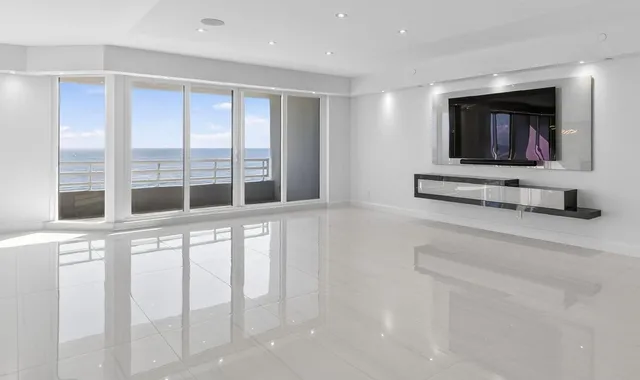 a living room with a large window and a flat screen tv