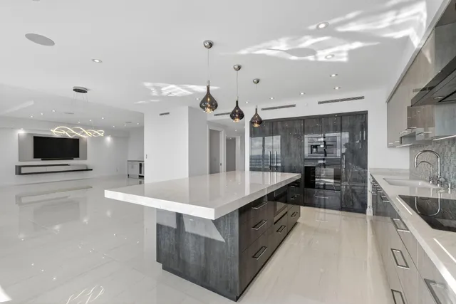 a view of an empty room with a flat screen tv and floor to ceiling window