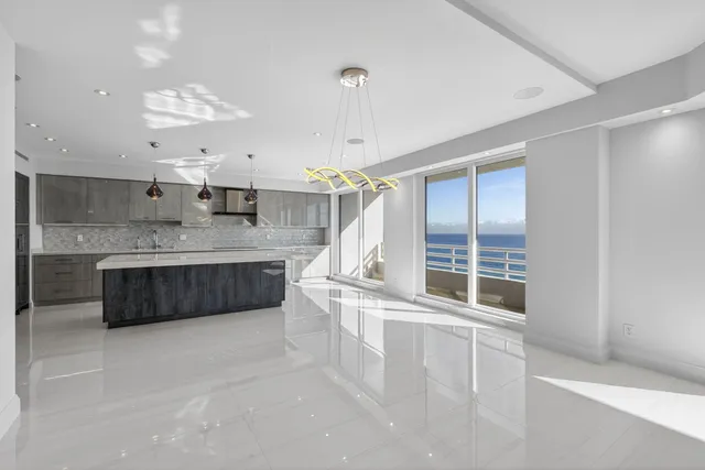 a bathroom with a granite countertop toilet sink and mirror