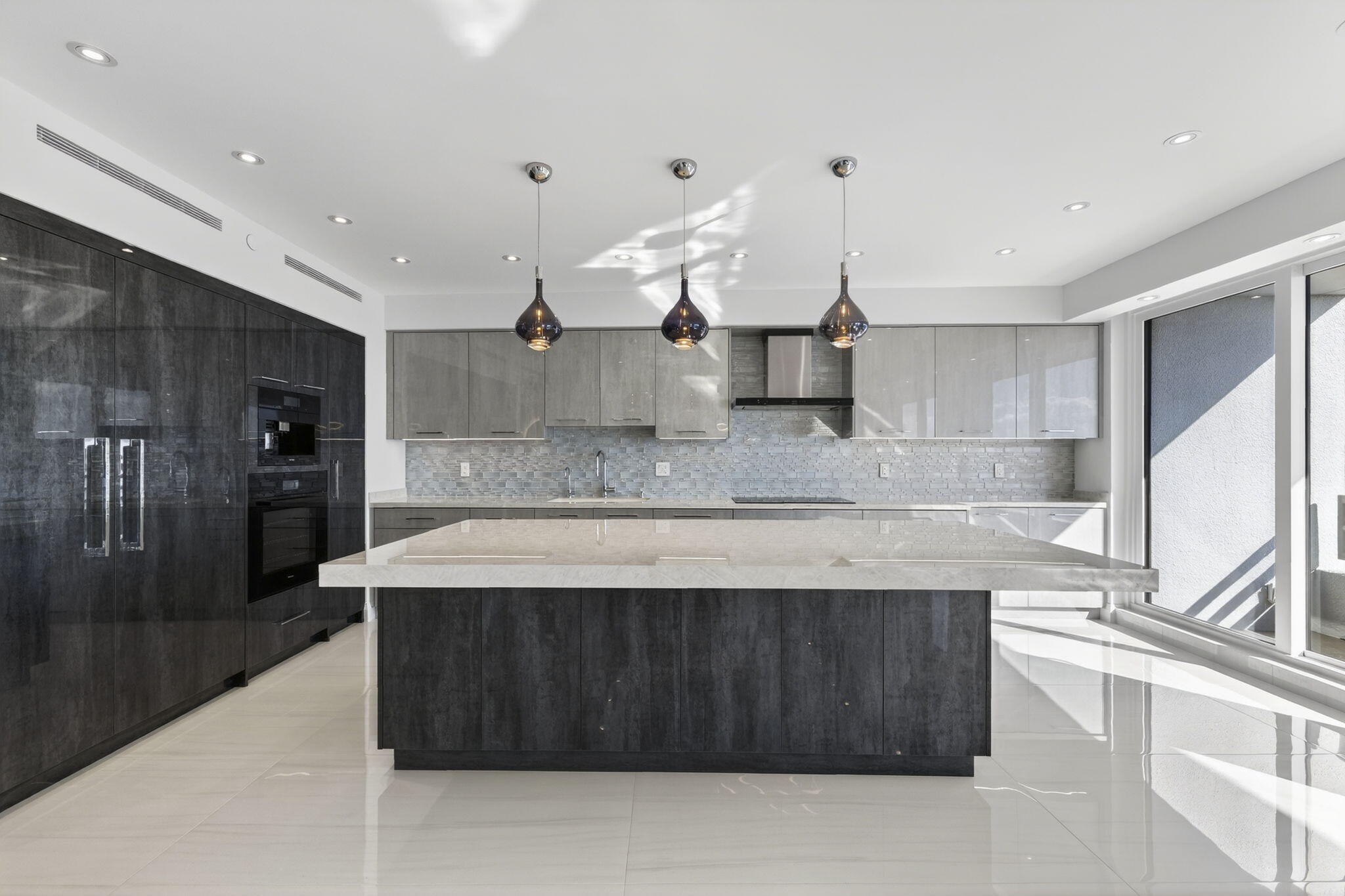 1500 South Ocean Boulevard, Unit 1602 Boca Raton, FL 33432 - Photo 18 of 88 a kitchen with kitchen island a counter top space a sink stainless steel appliances and cabinets