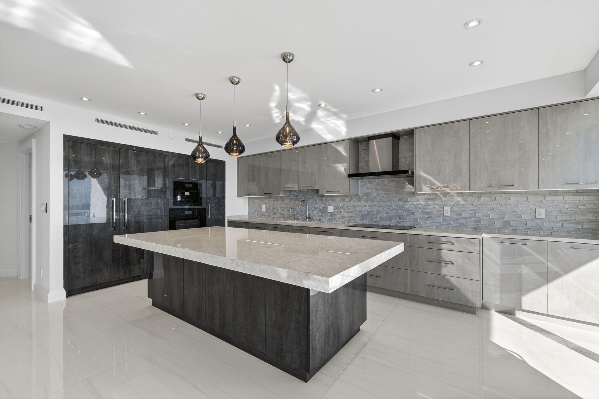 1500 South Ocean Boulevard, Unit 1602 Boca Raton, FL 33432 - Photo 22 of 88 a large kitchen with kitchen island a large counter top and stainless steel appliances