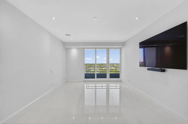 a dining room with furniture and a floor to ceiling window