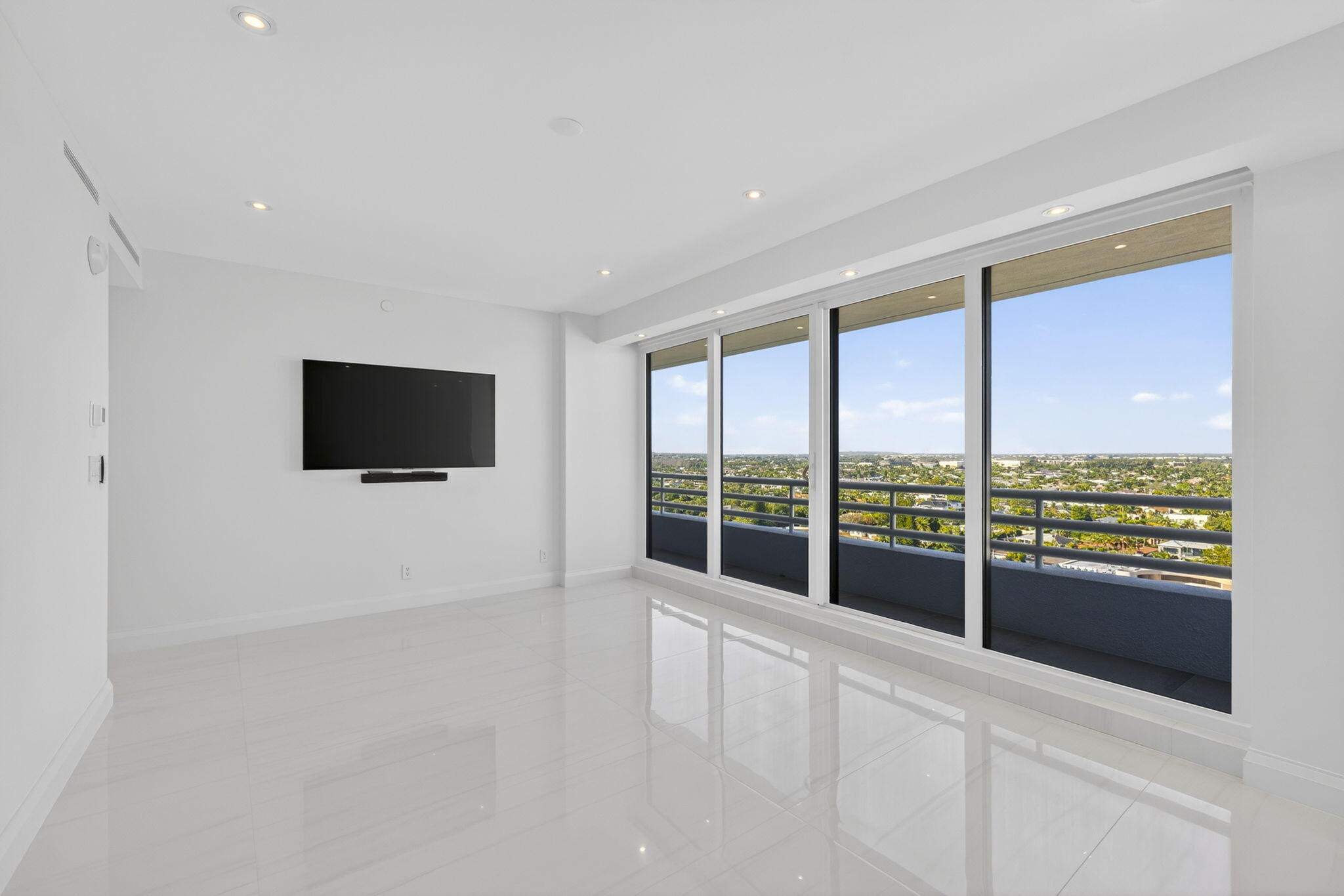 1500 South Ocean Boulevard, Unit 1602 Boca Raton, FL 33432 - Photo 42 of 88 a view of an empty room with a flat screen tv and floor to ceiling window