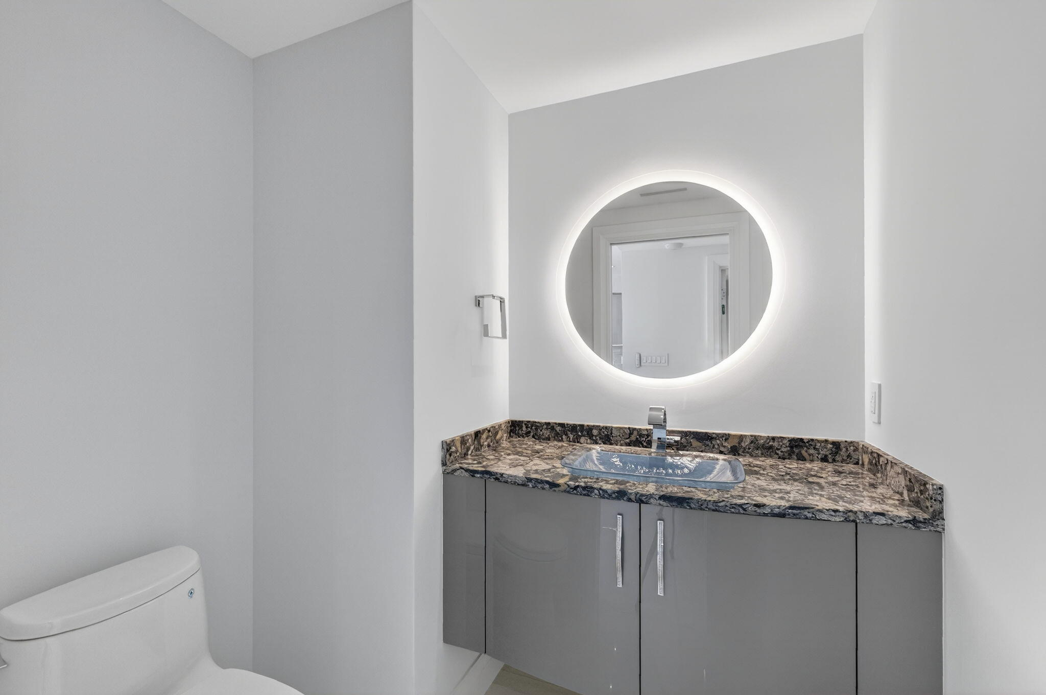 1500 South Ocean Boulevard, Unit 1602 Boca Raton, FL 33432 - Photo 47 of 88 a bathroom with a granite countertop toilet sink and mirror