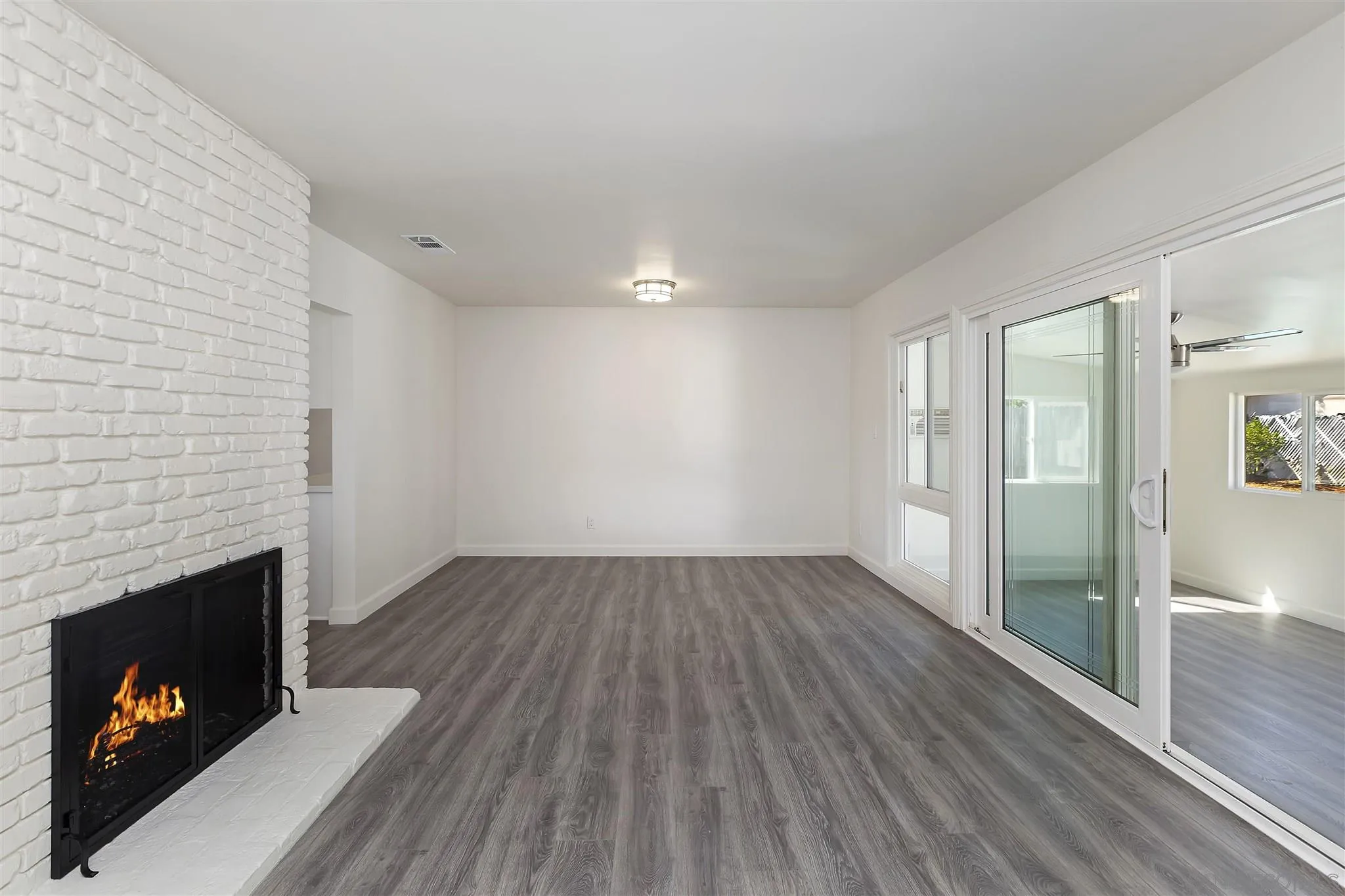2956 Ronald Street Riverside, CA 92506 - Photo 11 of 28 a view of an empty room with wooden floor and a fireplace