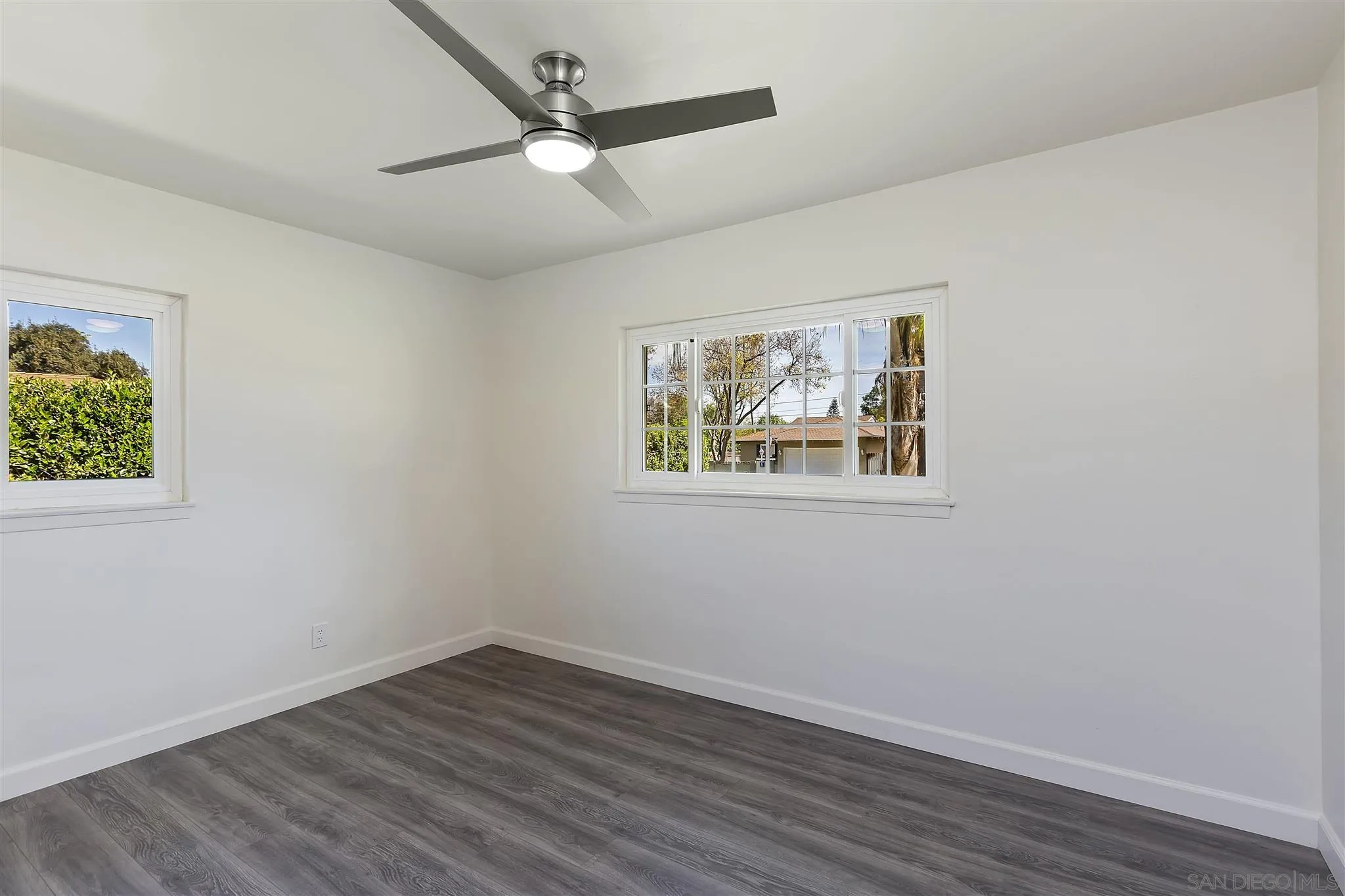 2956 Ronald Street Riverside, CA 92506 - Photo 17 of 28 a view of an empty room with wooden floor and a window