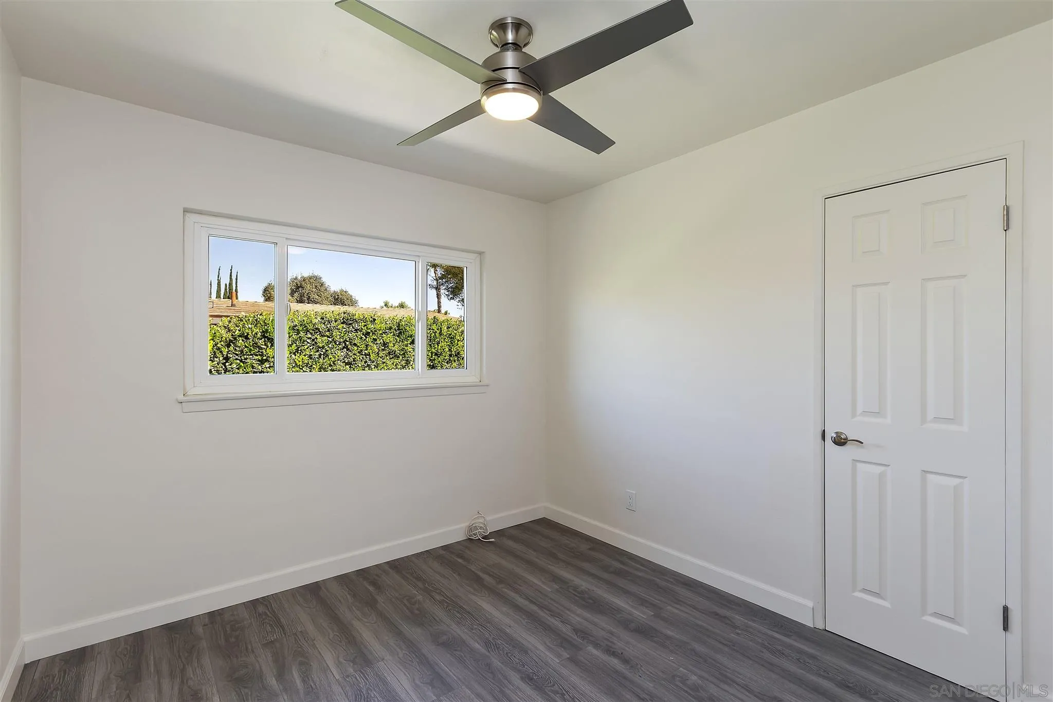 2956 Ronald Street Riverside, CA 92506 - Photo 18 of 28 an empty room with a window and a ceiling fan