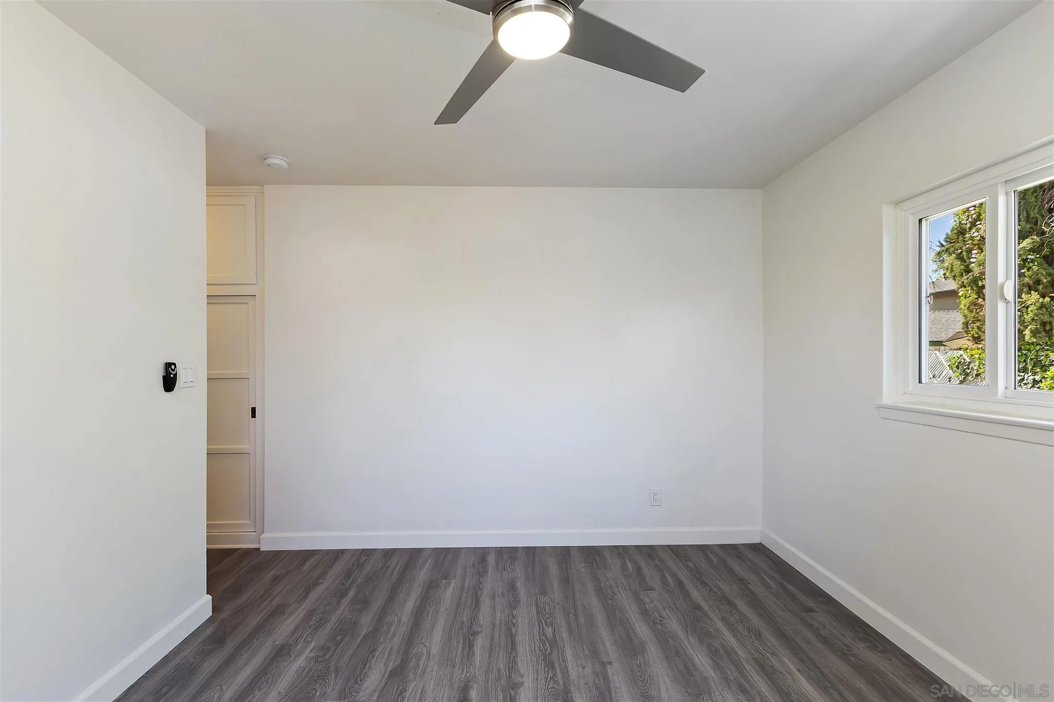 2956 Ronald Street Riverside, CA 92506 - Photo 22 of 28 wooden floor in an empty room with a window
