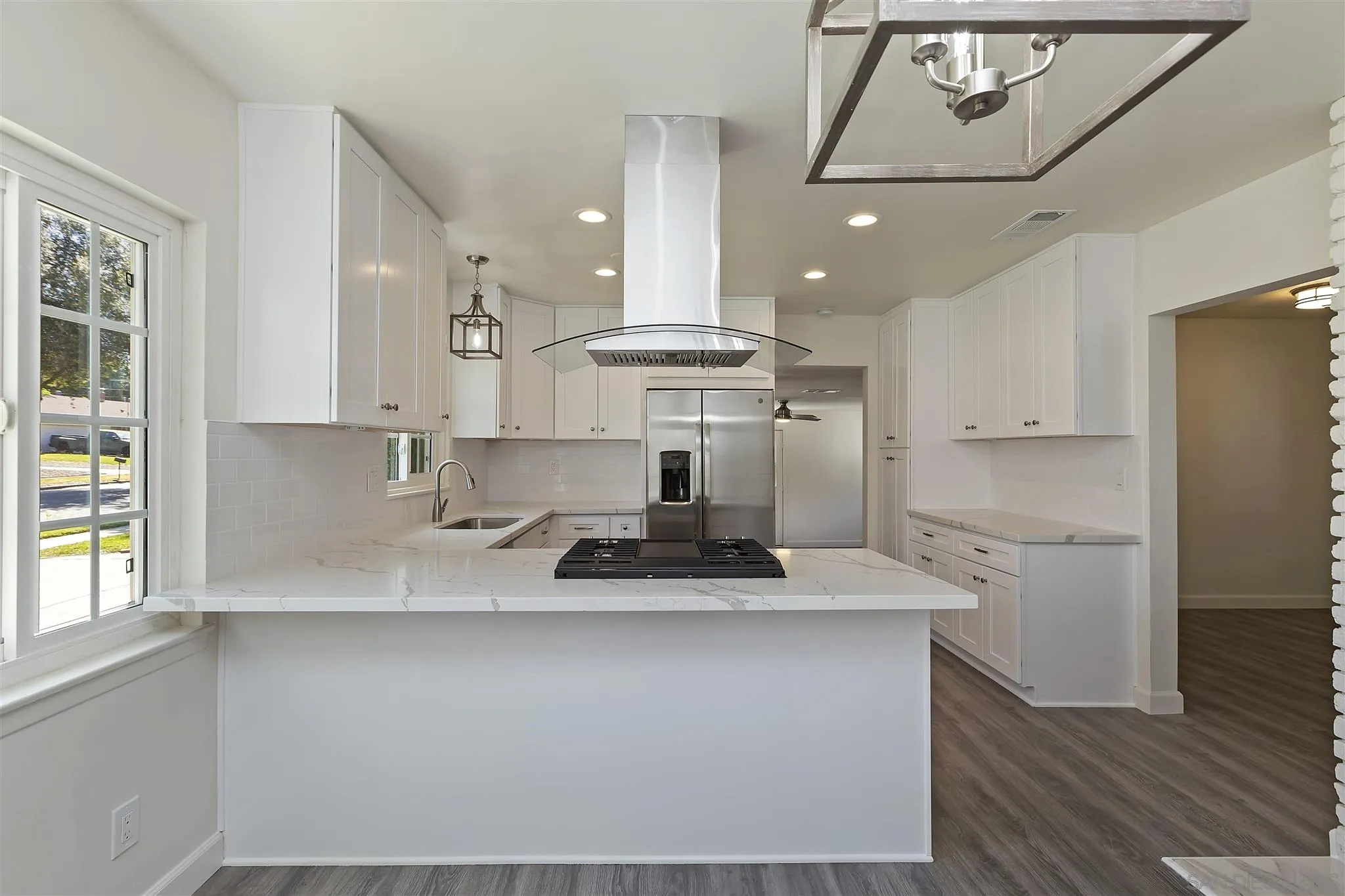 2956 Ronald Street Riverside, CA 92506 - Photo 5 of 28 a kitchen with kitchen island white cabinets and refrigerator