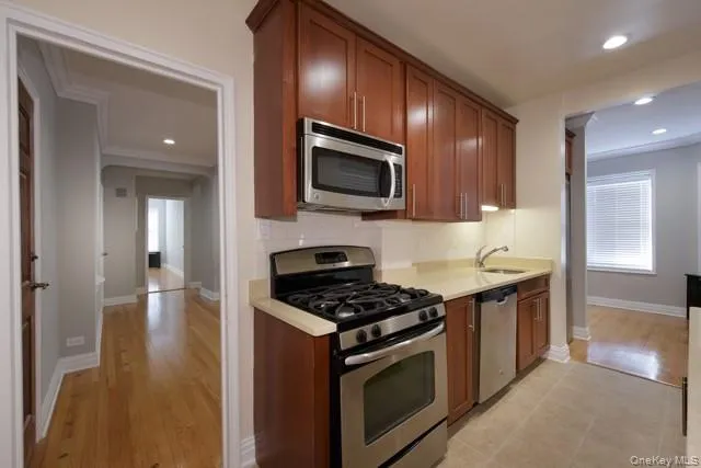 a kitchen with granite countertop stainless steel appliances and cabinets