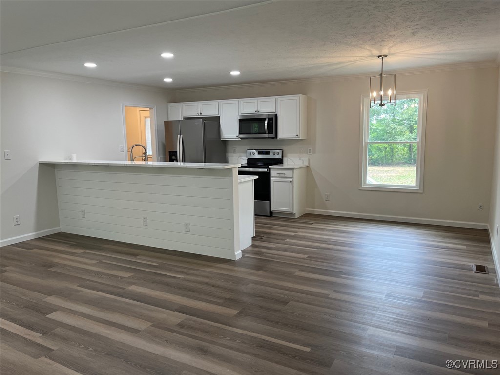 2861 Pattie Road Buckingham, VA 23921 - Photo 3 of 20 an open kitchen with kitchen island granite countertop a stove top oven a sink and dishwasher with wooden floor