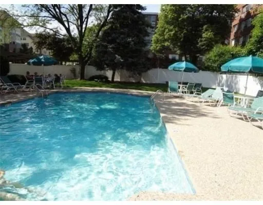 a view of a house with swimming pool and sitting area