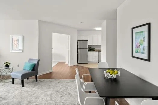 a living room with furniture and kitchen view