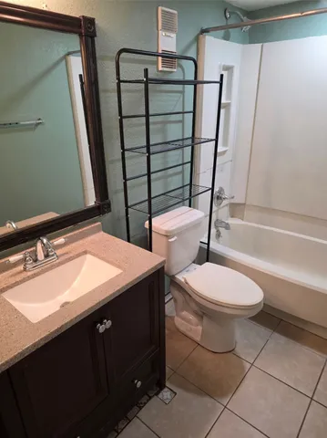 a bathroom with a sink a toilet a mirror and shower