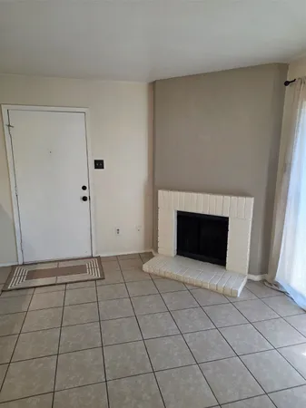a view of an empty room with a fireplace