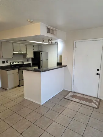 a kitchen with stainless steel appliances granite countertop a sink and a stove top oven