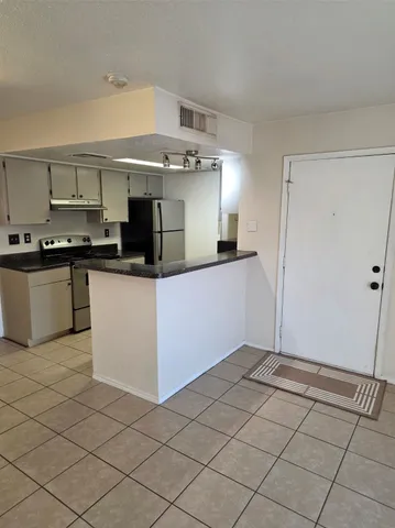 a kitchen with stainless steel appliances granite countertop a sink and a stove top oven