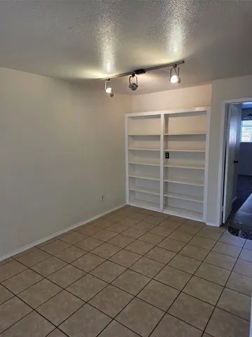 a view of walk in closet with clothes